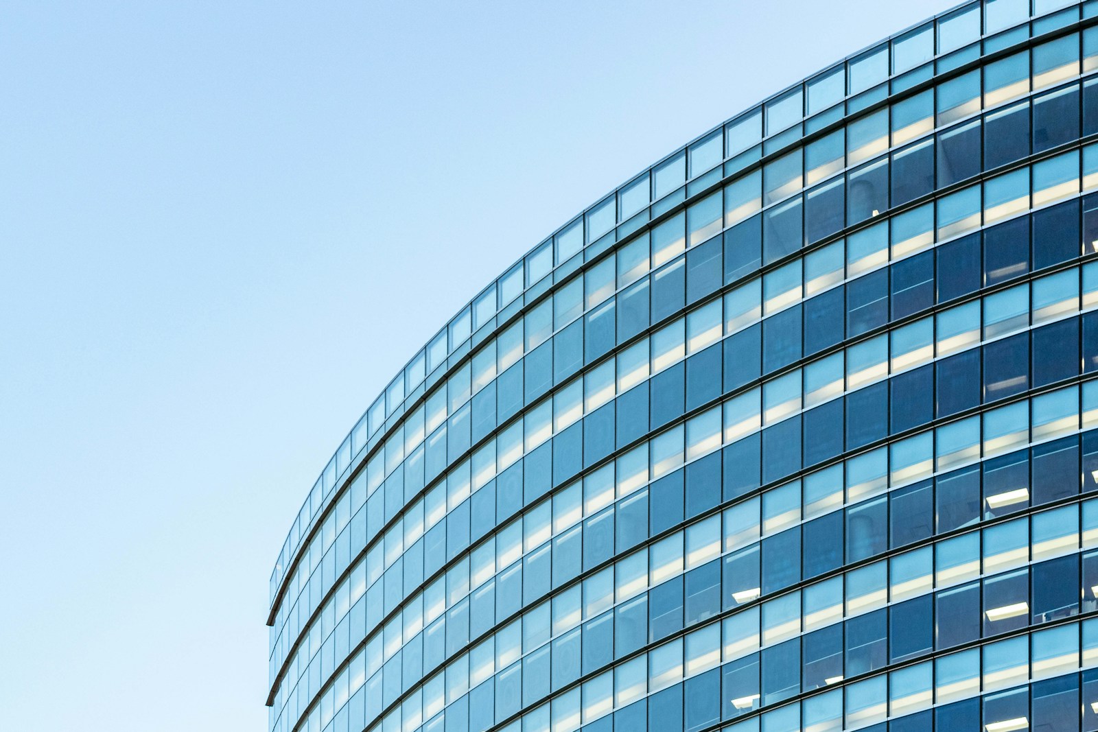 Curved glass architecture looking towards the sky